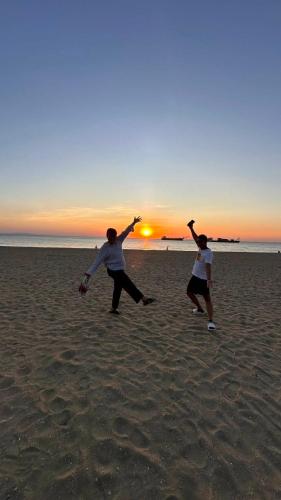 two people playing with a frisbee on the beach at KP Seaview Jomtien in Na Jomtien
