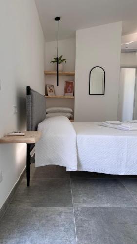 a bedroom with a large bed and a table at Le maree di Cofano in Custonaci