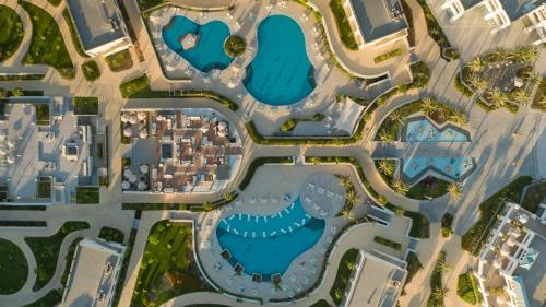 an aerial view of a city with buildings and water at Cleopatra Sidi Heneish in Marsa Matruh