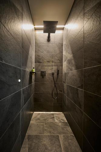 a bathroom with a shower with tiled walls at sGmiatli – Dein Hideaway Apartment in Kappl