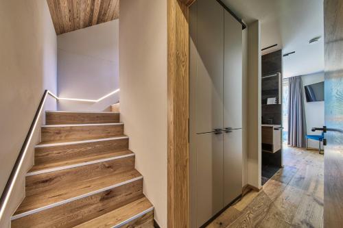 a staircase in a house with wood floors and a door at sGmiatli – Dein Hideaway Apartment in Kappl