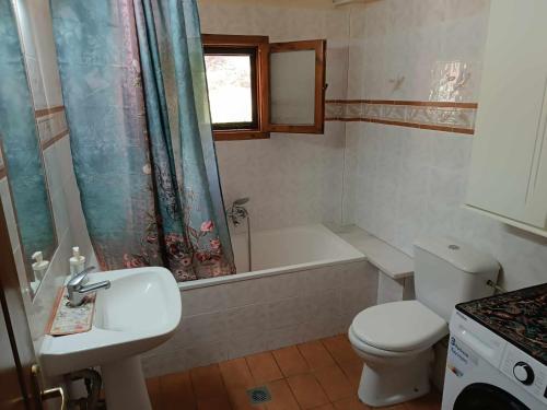 a bathroom with a sink and a toilet and a bath tub at Rainbow Castle Villa neos panteleimonas in Neos Panteleimonas
