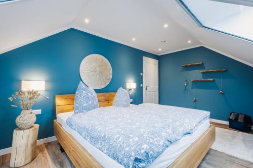 una camera da letto blu con un letto con pareti blu di Ferienwohnung Auszeit a Zingst