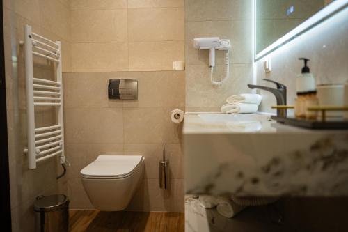 a bathroom with a toilet and a sink at Aurora Sofia in Sofia
