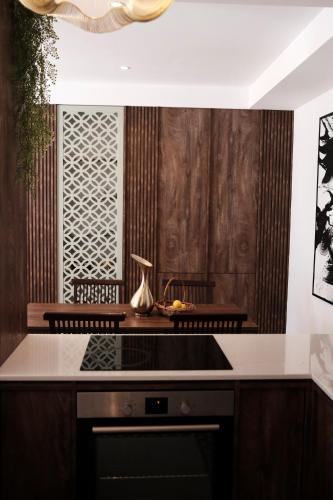 a kitchen with wooden walls and a stove top oven at Palastura Apartments in Ulcinj