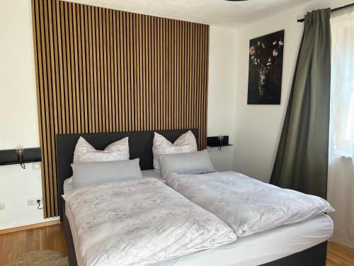a bedroom with a large bed with white sheets at Haus Annabelle in Wagrain