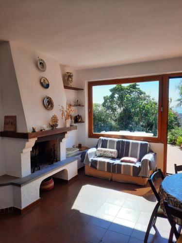 a living room with a couch and a fireplace at Casa Celeste in Albinia