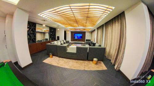 a living room with a couch and a television at Fiora Hotel in Murree