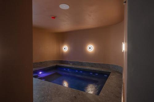 a swimming pool with blue lights in a room at Best Western Premier Malta in St Paul's Bay