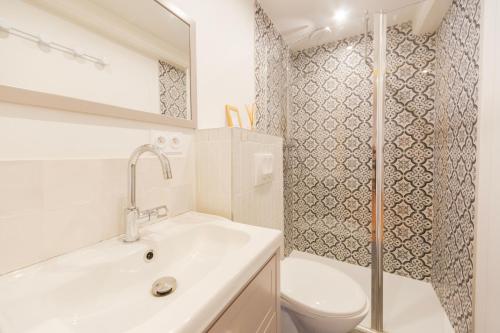 a bathroom with a sink and a toilet and a shower at Domaine de La Baisse in Saint-Étienne-la-Varenne