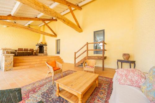 a living room with a couch and a table at Domaine de La Baisse in Saint-Étienne-la-Varenne