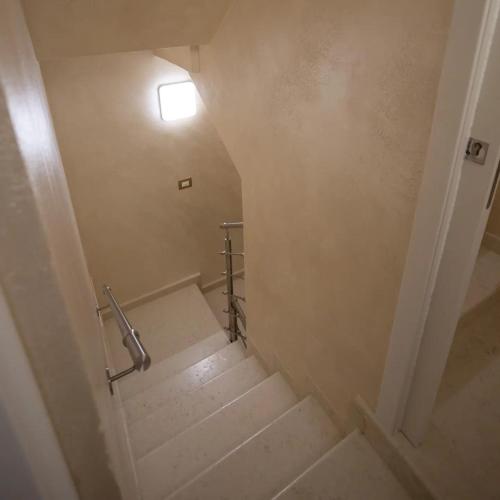a staircase in a bathroom with a light on the wall at Dal Doge - Guest House in Chioggia