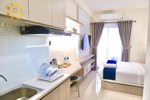 a small bathroom with a sink and a bed at Royal Suites Studio 11QX - Citra Plaza Nagoya in Jodoh
