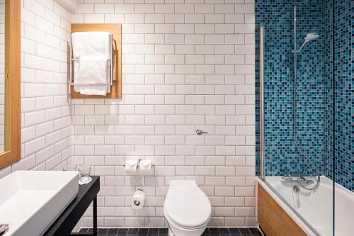 a bathroom with a toilet and a sink and a shower at Holiday Inn London - Gatwick Airport by IHG in Horley