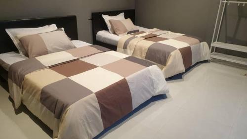 two beds sitting next to each other in a bedroom at Blossom House Zanzibar in Kitongani