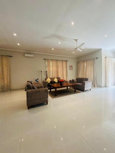 a living room with two couches and a table at Blossom House Zanzibar in Kitongani