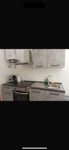 a kitchen with a sink and a stove at Fiore Apartments in Fiorenzuola dʼArda