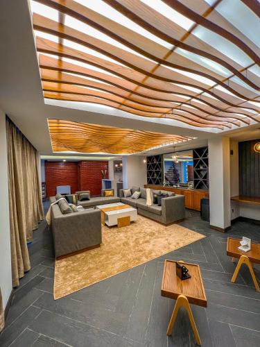 a lobby with couches and tables in a building at Fiora Hotel in Murree