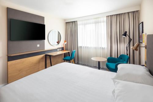 a hotel room with a bed and a tv at Holiday Inn London - Gatwick Airport by IHG in Horley