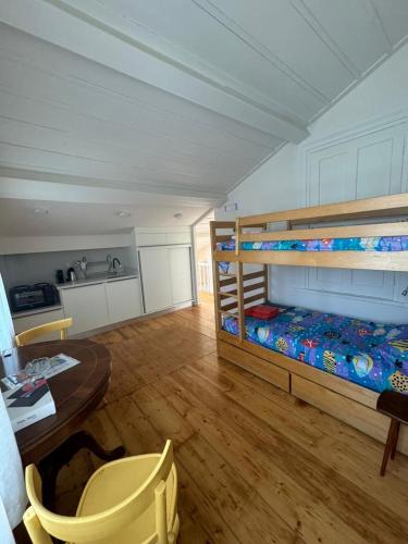a room with a bunk bed and a desk and a table at 1906 Citygarden in Chios