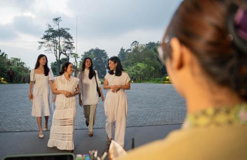 a group of women standing on a bridge at Plataran Puncak Residences in Puncak