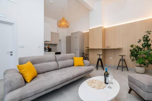 a living room with a couch and a table at President Bungalows and Apartments in Utjeha