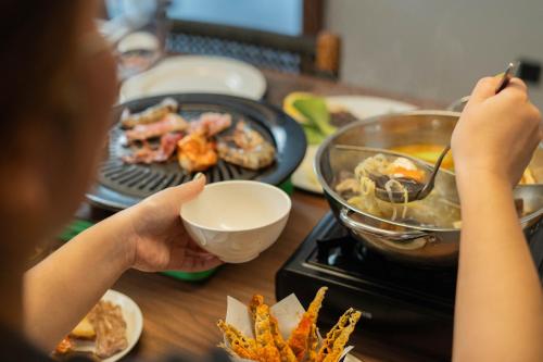 a child is cooking food on a stove at Plataran Puncak Residences in Puncak