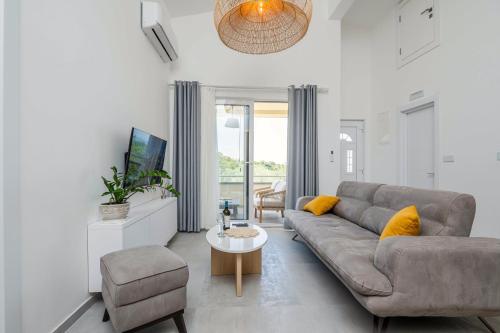 a living room with a couch and a table at President Bungalows and Apartments in Utjeha