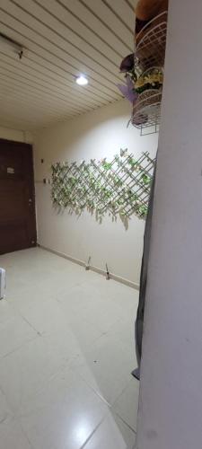 a room with a wall with plants on the wall at MAMA DELiGHT HOME in Abu Dhabi