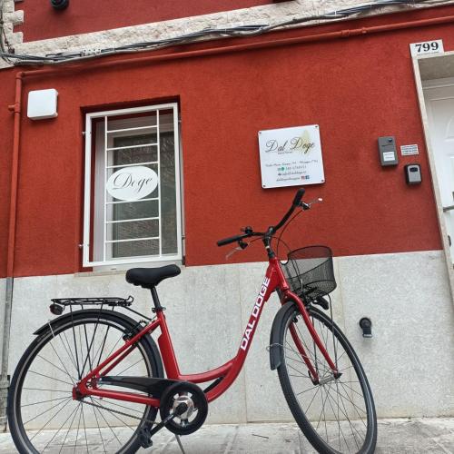 a red bike parked in front of a building at Dal Doge - Guest House in Chioggia