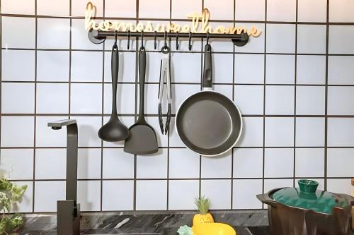a kitchen with utensils hanging on a wall at Hotel Serviced Apartments Top One Infinity Pool with View of 360 Degree in Phnom Penh