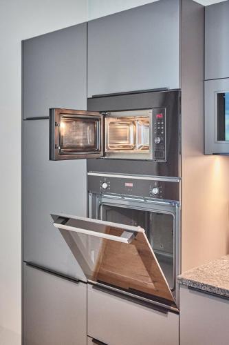 a kitchen with two ovens in a kitchen at sGmiatli – Dein Hideaway Apartment in Kappl