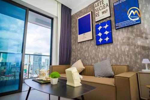 a living room with a couch and a table at Hotel Serviced Apartments Top One Infinity Pool with View of 360 Degree in Phnom Penh