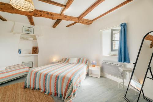 a bedroom with a bed and a window at Ancien moulin à vent du 19e siècle in Cherrueix