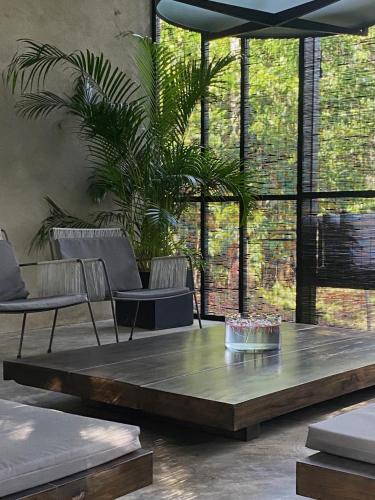 a living room with a wooden table and chairs at KAJU GREEN eco lodges in Unawatuna