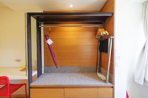 a closet with an umbrella in a room at The Salvation Army - Booth Lodge in Hong Kong