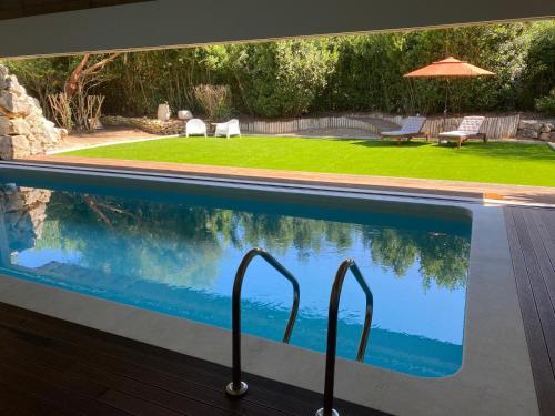 a swimming pool with a view of a yard at Poolside Suite - Quinta da BellaVista in Santarém