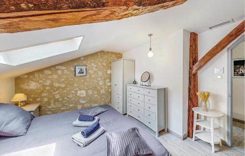 a bedroom with a bed and a dresser in a room at Nice Home In Mareuil En Perigord in Cercles