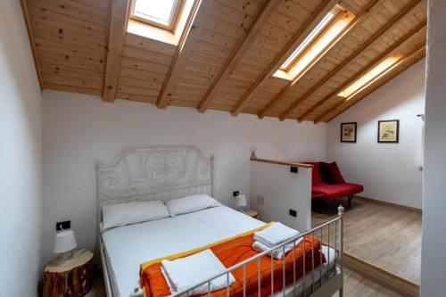 a bedroom with a bed and a red chair at SOLENEVE in San Domenico