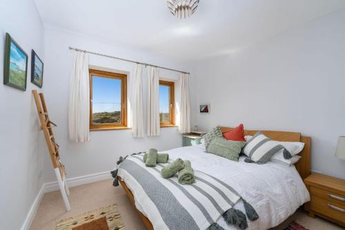 a bedroom with a bed with two teddy bears on it at Property 464 - Claddaghduff in Claddaghduff