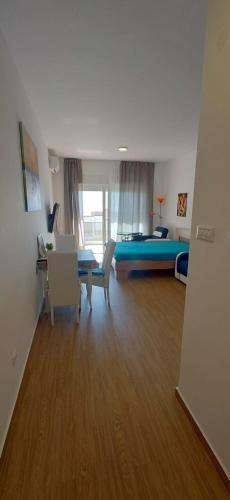 a room with a bed and a table and chairs at Your Home Montenegro in Dobra Voda