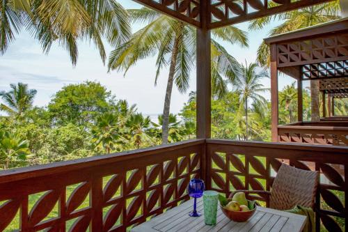 a table on the balcony of a resort with a bowl of fruit at Melia Zanzibar in Kiwengwa
