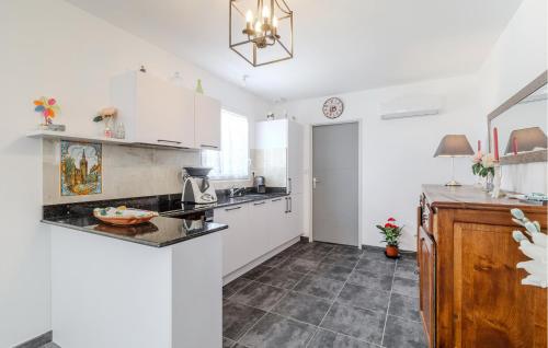 une cuisine avec des armoires blanches et un comptoir dans l'établissement Stunning Home In Marennes-Hiers-Brouage, à Marennes