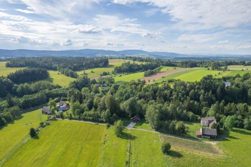 an aerial view of a green field with houses and trees at Agroturystyka W oddali z balią in Międzylesie