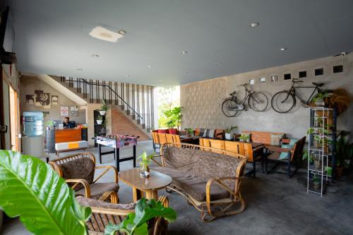 a room with chairs and tables and bikes on the wall at RedDoorz Syariah near Lombok Epicentrum Mall in Mataram