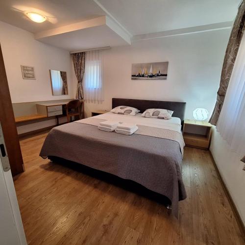 a bedroom with a bed with two towels on it at Apartments Chemenko in Konsko
