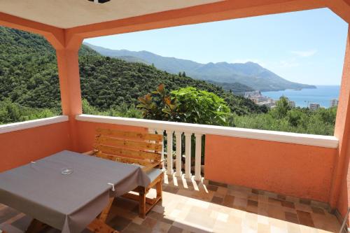 a balcony with a table and a view of the ocean at Apartmani Amra in Ivanovići