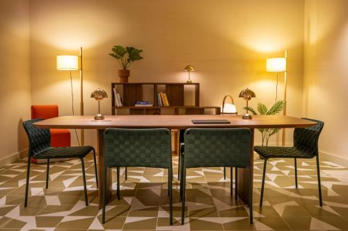 a conference room with a wooden table and chairs at Ocean Drive Sevilla in Seville