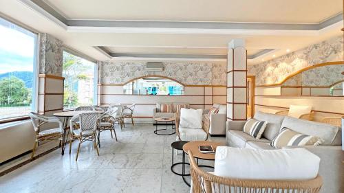a living room with a couch and tables and chairs at Moon Dreams Noja in Noja