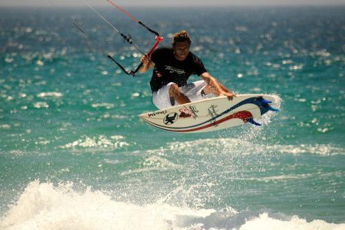 a man riding a wave on a surfboard in the ocean at Bungalows Tangana in Tarifa